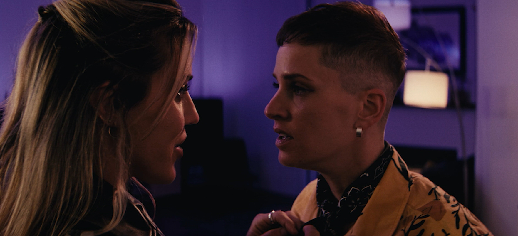 Two women look at each other, about to kiss