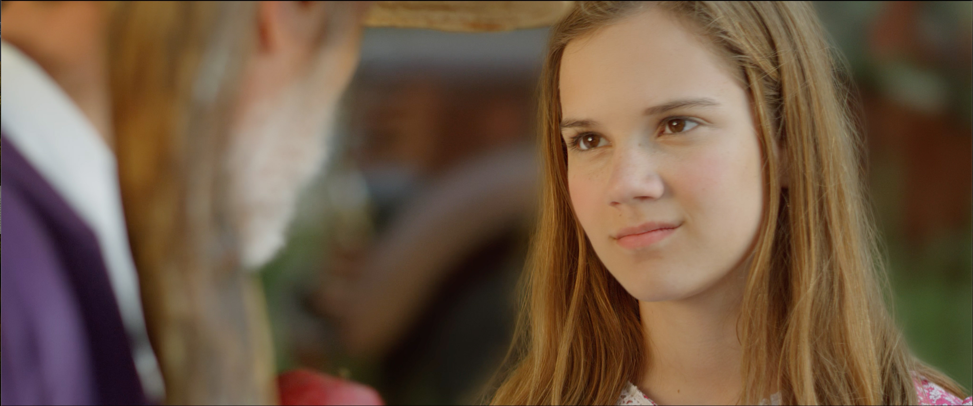 A young girl looks skeptically at her grandfather